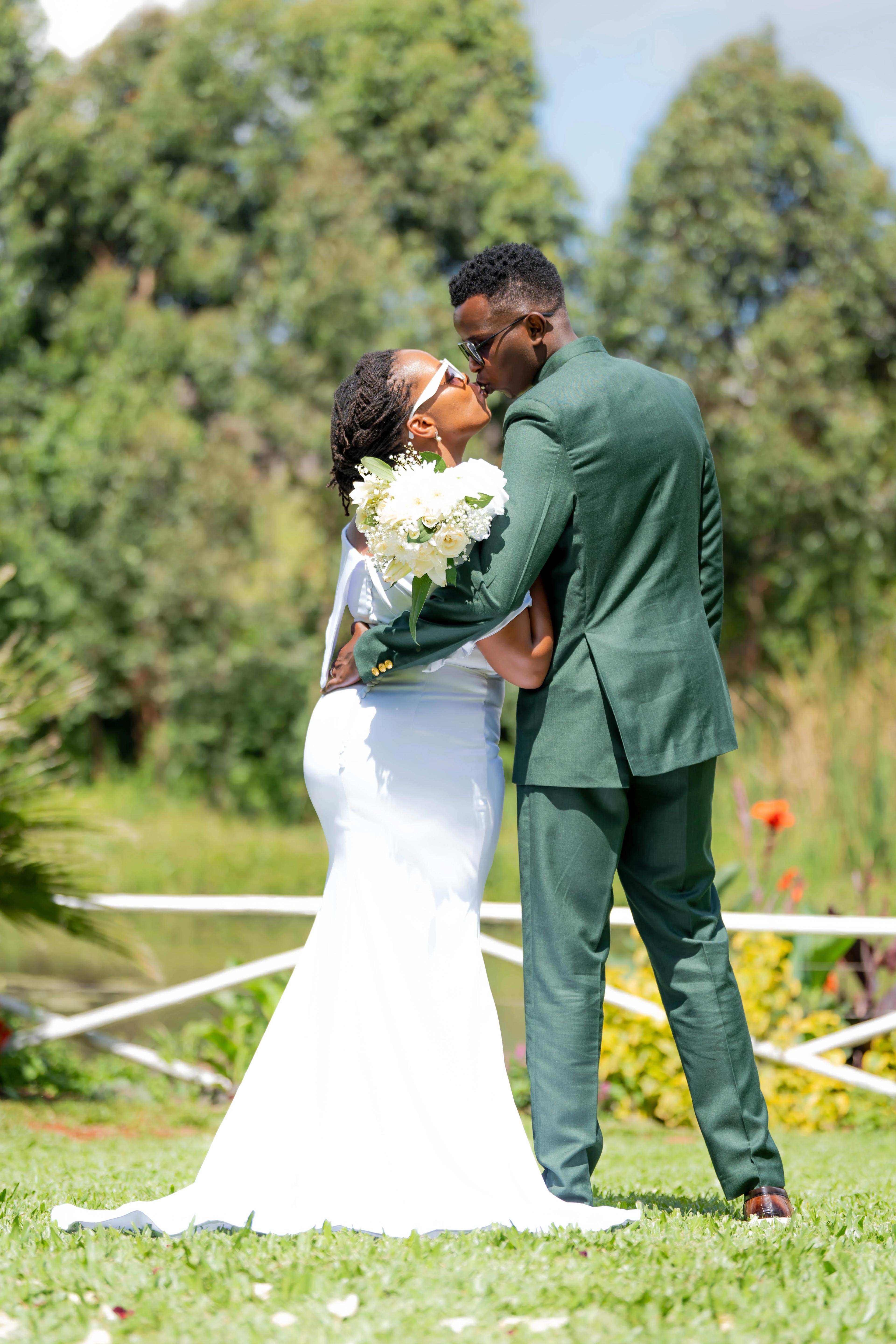 Bride and groom walking through a sunlit garden, candid moment captured between vows.