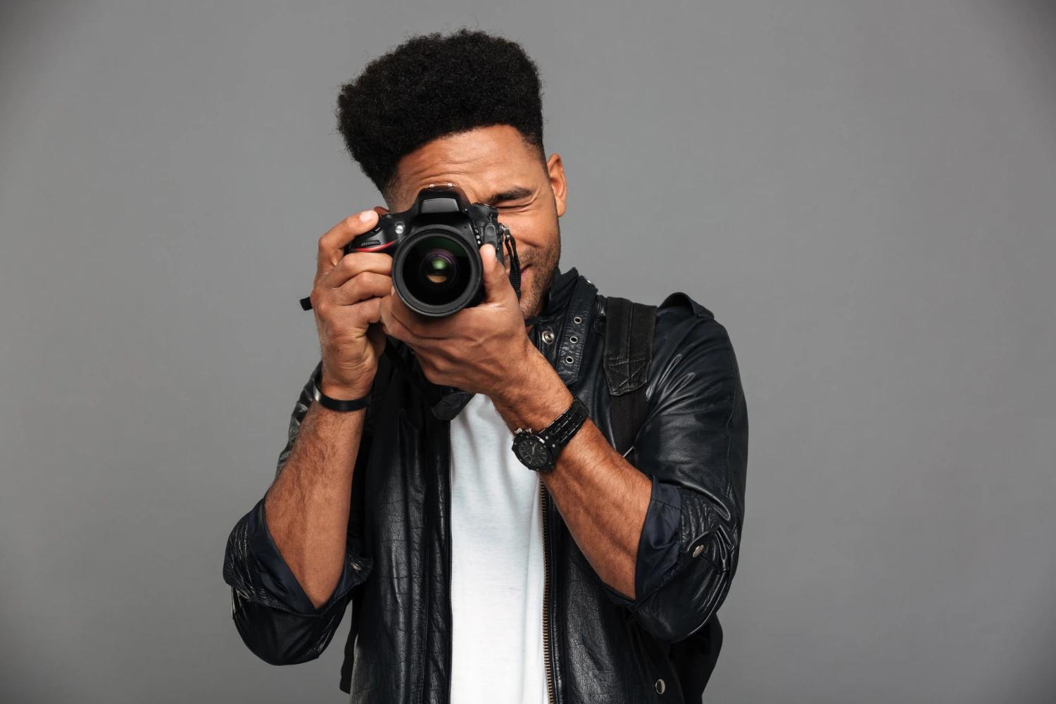 Portrait of director Gerald Kamau holding a camera on set
